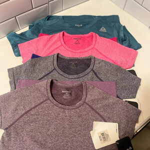 Four Reebok new sports tops, beautiful colors all brand new with a tag